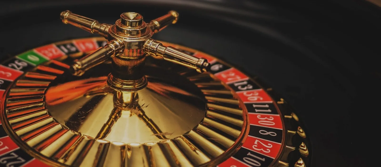 Roulette wheel under warm casino light
