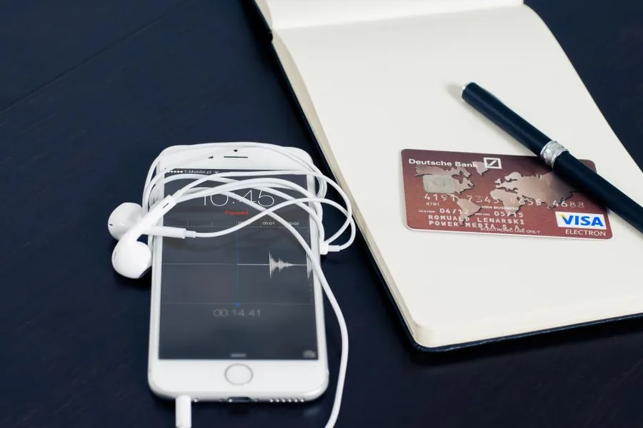 Bank card, phone and notebook on a desk