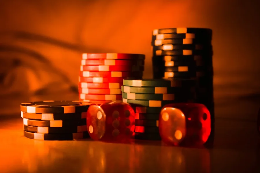 Stacks of casino chips and red dice