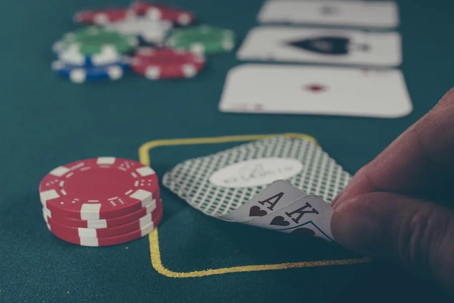 Poker hand and chips on green felt